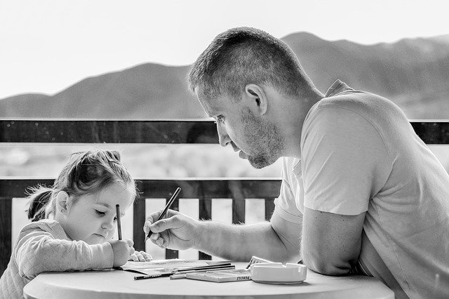 Girl with Dad homeschooling during Coronavirus